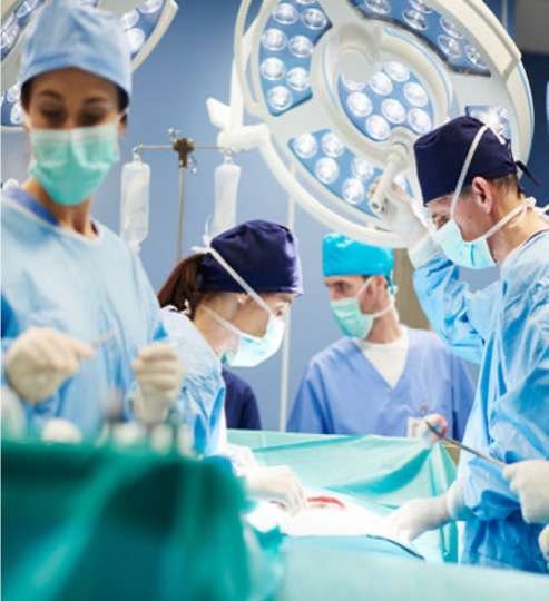 Surgeons performing operation in operating room