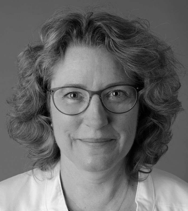 Black and white portrait of a woman with glasses.