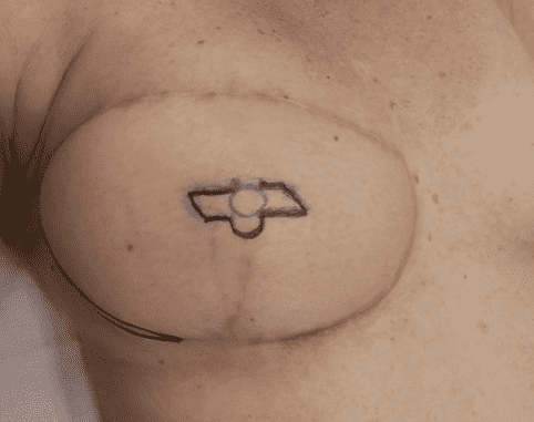 Tattoo outline on chest with symbol.