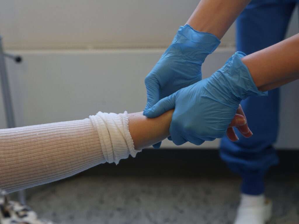 Healthcare professional holding a patient's arm