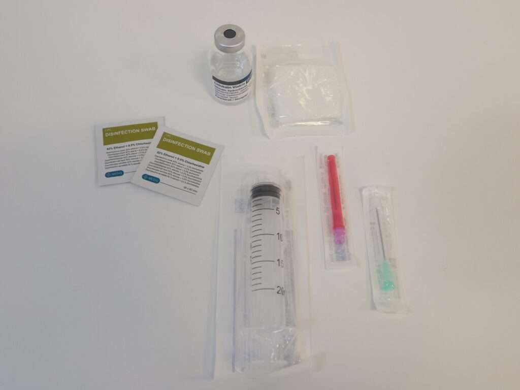 Medical injection preparation kit on a table.